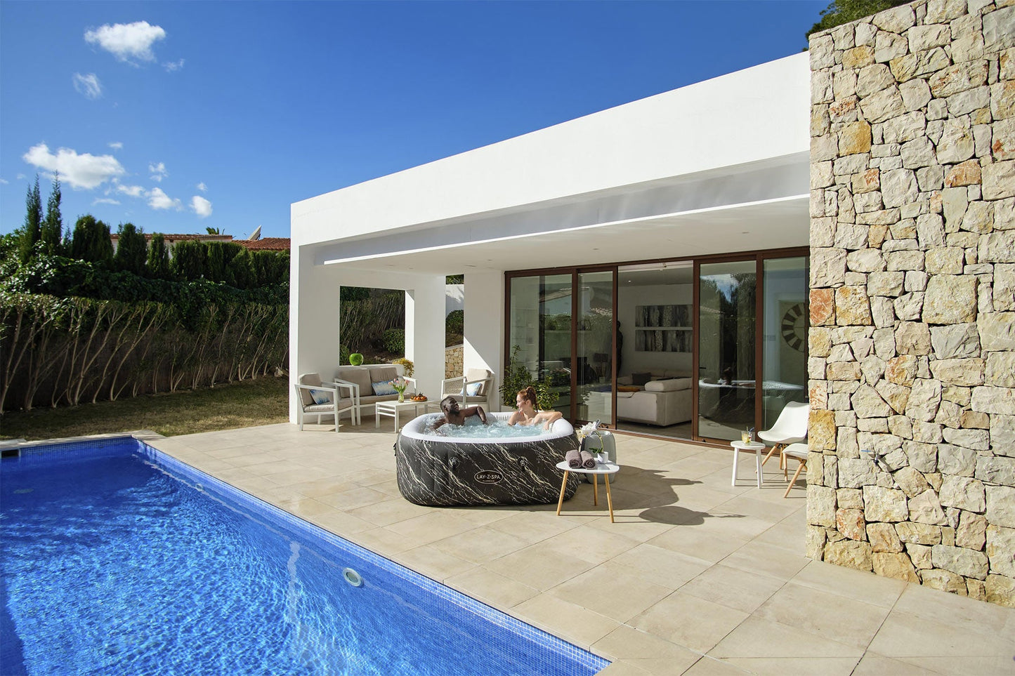 Modern house exterior with a pool and outdoor furniture