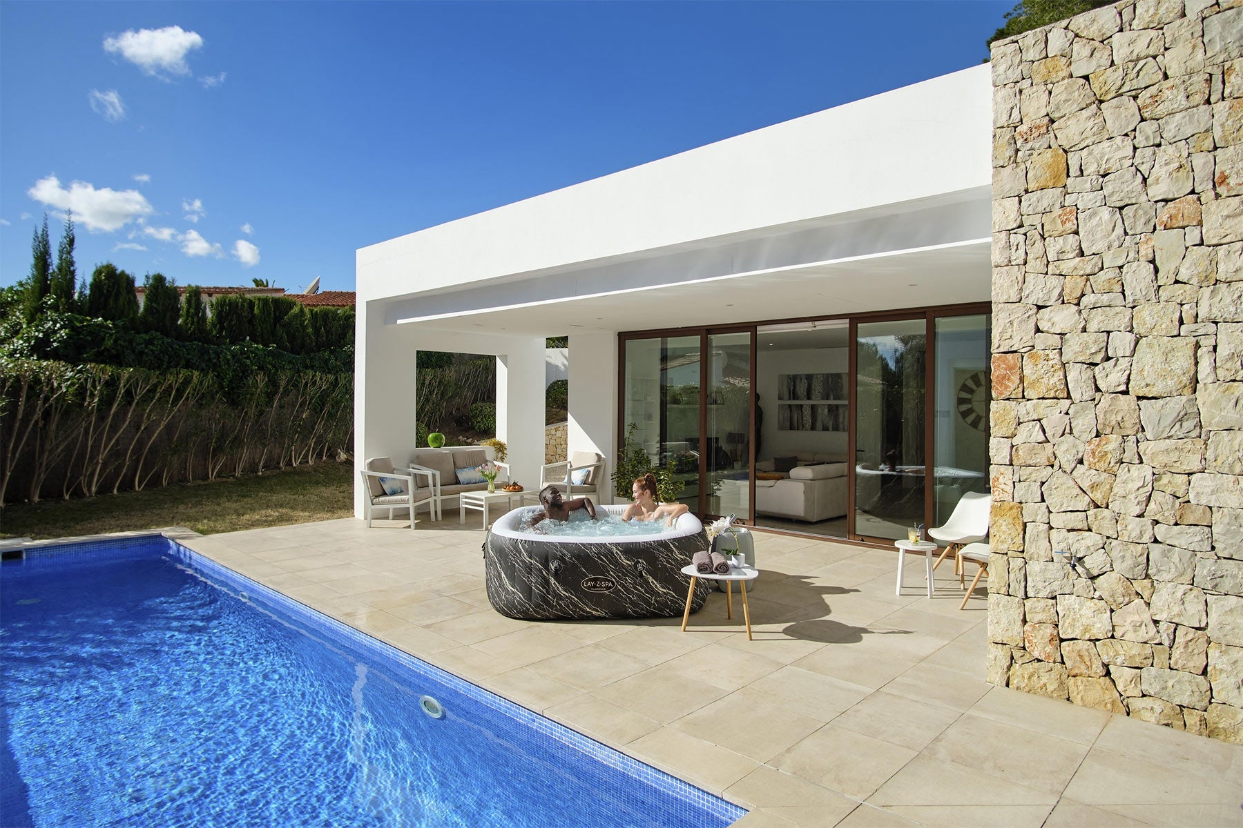 Modern house exterior with a pool and outdoor furniture