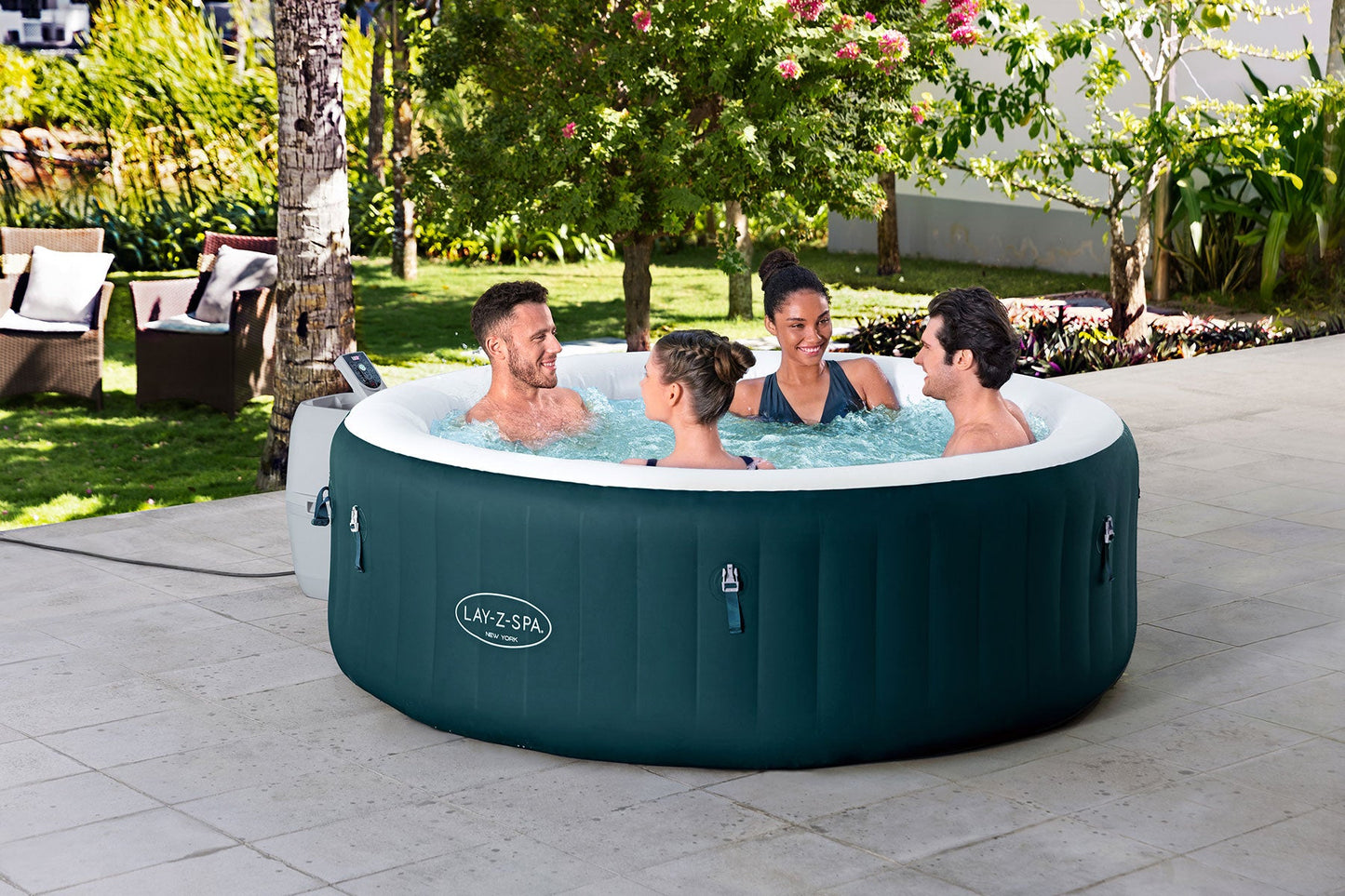 Inflatable hot tub with people in a garden setting