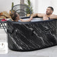 Inflatable hot tub with marble design being used by a couple in an outdoor setting.