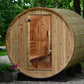 Princeton Wooden barrel-shaped sauna in a natural setting with trees and flowers.