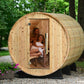 Wooden Princeton outdoor sauna with people inside, surrounded by greenery