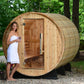 Princeton Wooden outdoor sauna with a woman standing outside, holding a glass.