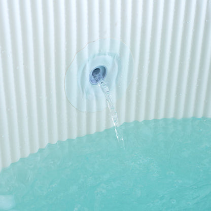 Water fountain with water flowing into a green container against a white background