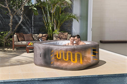 Two people in a hot tub with visible water circulation system, surrounded by outdoor furniture and plants.