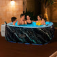 Family of five enjoying a hot tub in a warm indoor setting