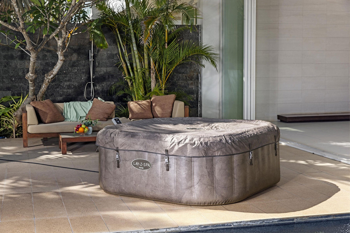 Inflatable hot tub on a patio with outdoor furniture and plants