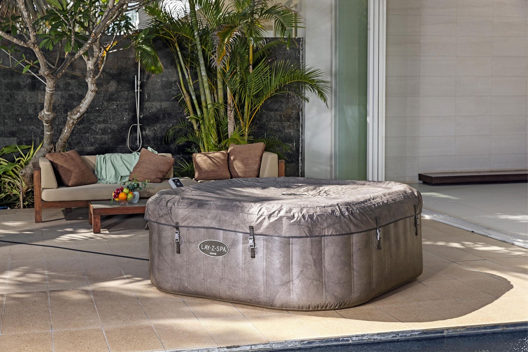 Inflatable hot tub on a patio with outdoor furniture and plants