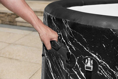 Person opening a black marble-patterned trash can with a white interior.
