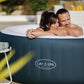 Two people in a Lay-Z-Spa hot tub outdoors