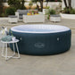 Inflatable hot tub with 'Lay-Z-Spa' branding on a patio area with outdoor furniture.