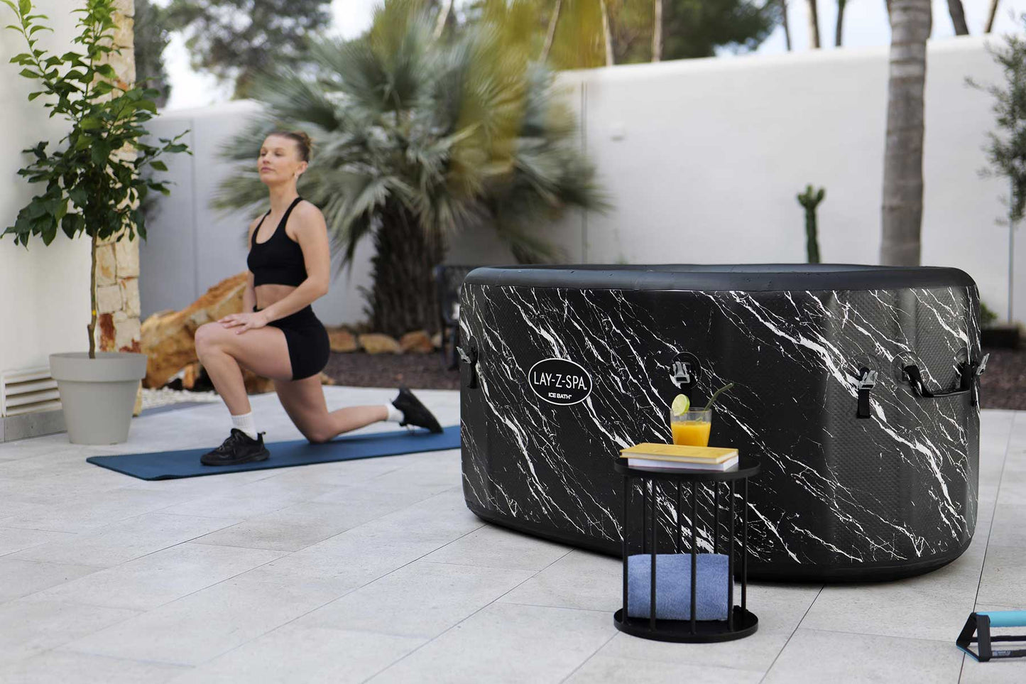 Woman exercising outdoors with a hot tub in the background