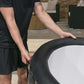 Person holding a hot tub cover outdoors on a patio